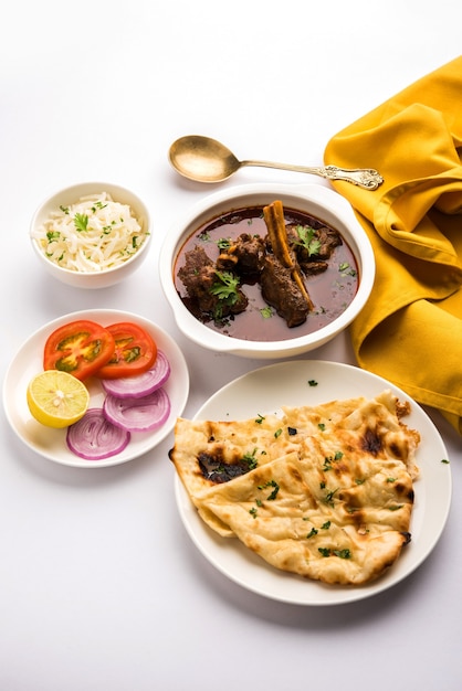 Mutton OR Gosht Masala OR indian lamb rogan josh with some seasoning, served with Naan or Roti, selective focus