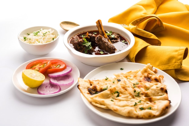 Mutton OR Gosht Masala OR indian lamb rogan josh with some seasoning, served with Naan or Roti, selective focus