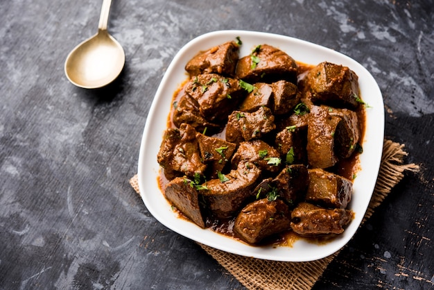 Mutton Liver fry or Kaleji masala, popular Non vegetarian recipe from India and Pakistan. served dry or with curry in a bowl, karahi or plate