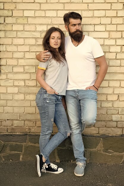 Mutual romance Sensual woman and bearded man enjoying romance in relationship Romantic couple in love hugging on brick wall Feeling romance Romance in love