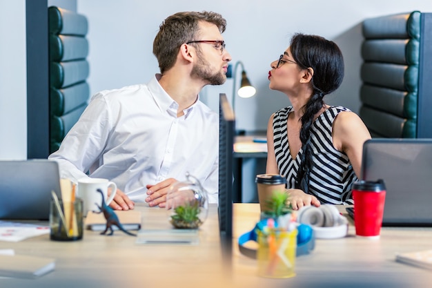 My boyfriend. Cheerful brunette man wearing glasses while looking at his partner