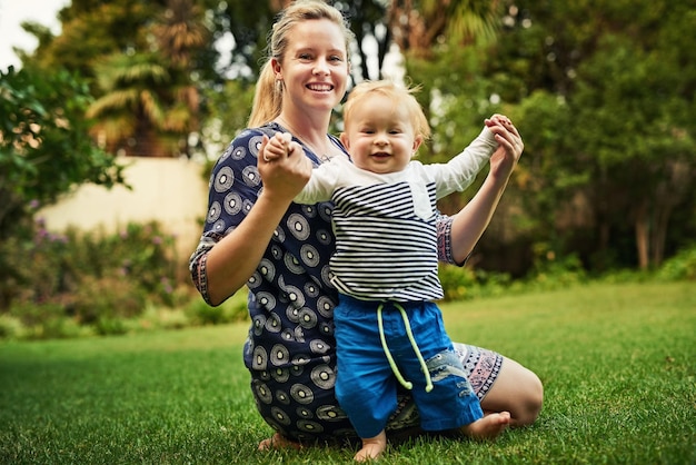 My first steps Shot of an adorable little boy and his mother playing in the backyard