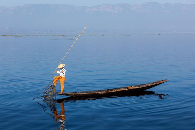 Myanmar travel attraction landmark Traditional Burmese fisherman at Inle lake Myanmar famous for their distinctive one legged rowing style