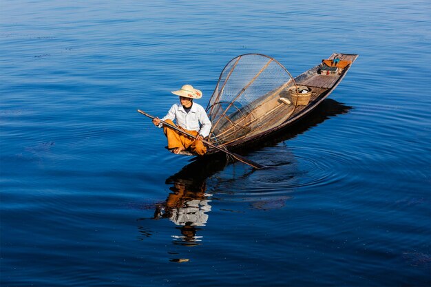 Myanmar travel attraction landmark Traditional Burmese fisherman at Inle lake Myanmar famous for their distinctive one legged rowing style