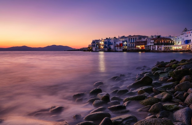 Mykonos Greece View of a traditional house in Mykonos The area of Little Venice Seascape during sunset Sea shore and beach Photo for travel and vacation