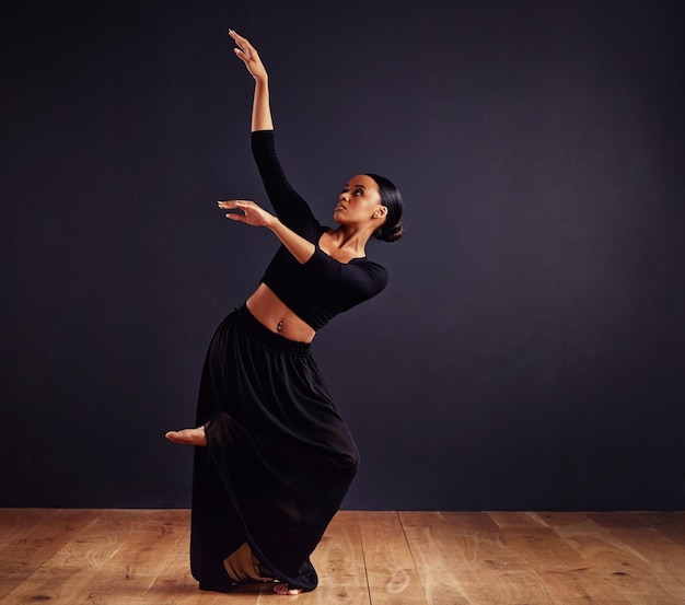 Mysteries of the dance female contemporary dancer in a dramatic pose against dark background