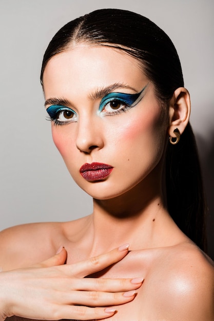 Mysterious beautiful young girl with blue shadows and beautiful facial features