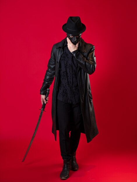 A mysterious ninja assassin in a noir style. A man in black leather clothes