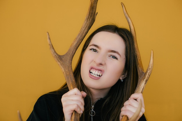 mysterious occult woman holding animal deer skull