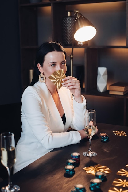 Mystic woman with golden cards at poker table