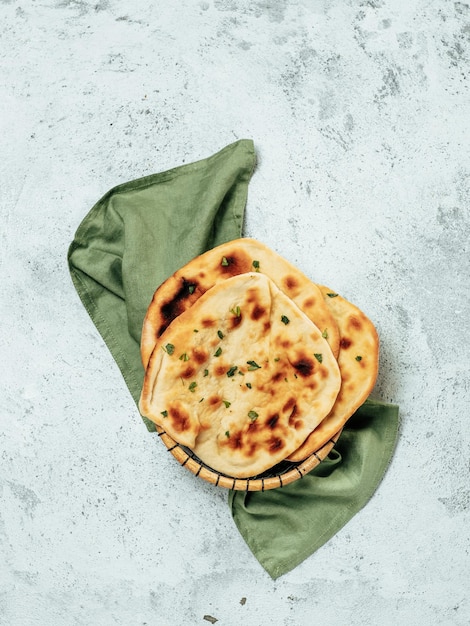 Photo naan flatbreads on gray cement copyspace vertical