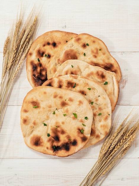 naan flatbreads on white wood copy space top view