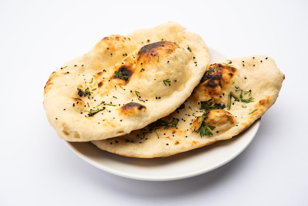 Naan nan bread served in a plate isolated