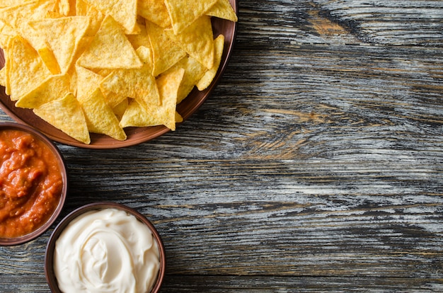 Nachos corn chips with spicy tomato and cheese sauces.