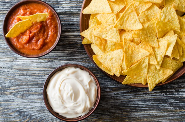 Nachos corn chips with spicy tomato and cheese sauces.