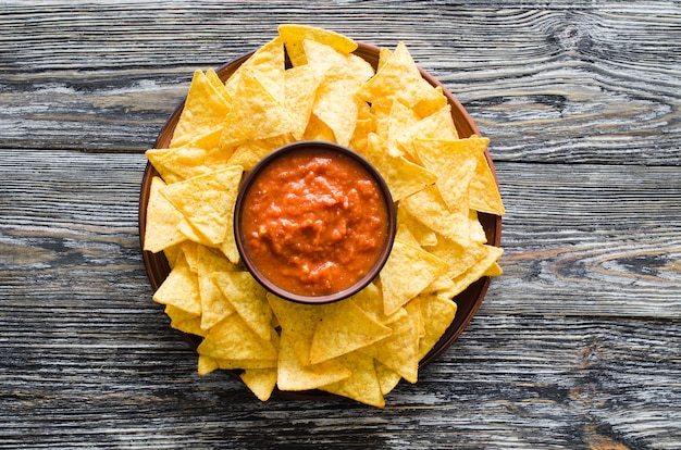 Photo nachos corn chips with spicy tomato sauce.