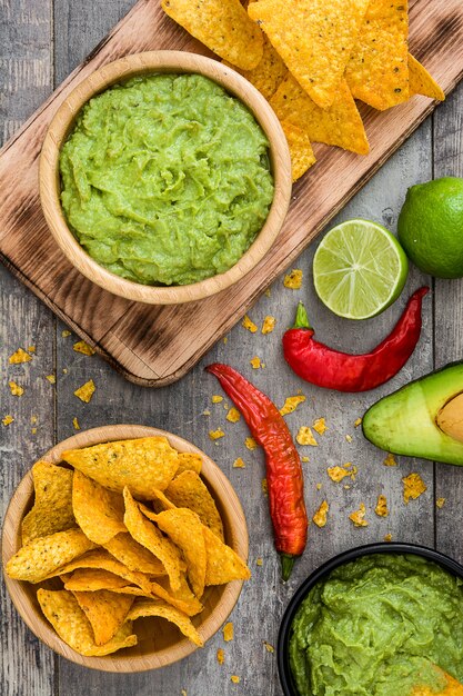 Nachos and guacamole on wooden  Top view