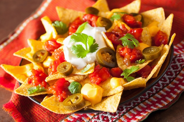 Nachos loaded with salsa, cheese and jalapeno