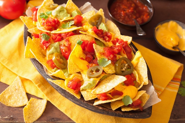 Nachos loaded with salsa, guacamole, cheese and jalapeno