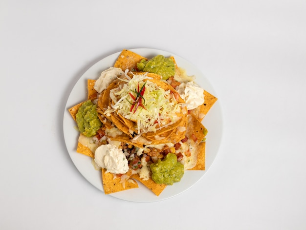 Nachos with guacamole cheese pico de gallo sour cream and veggies