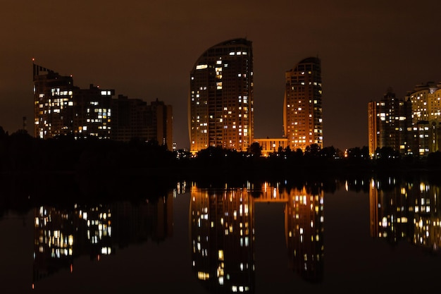 Nachtstad met weerspiegeling van huizen in de rivier