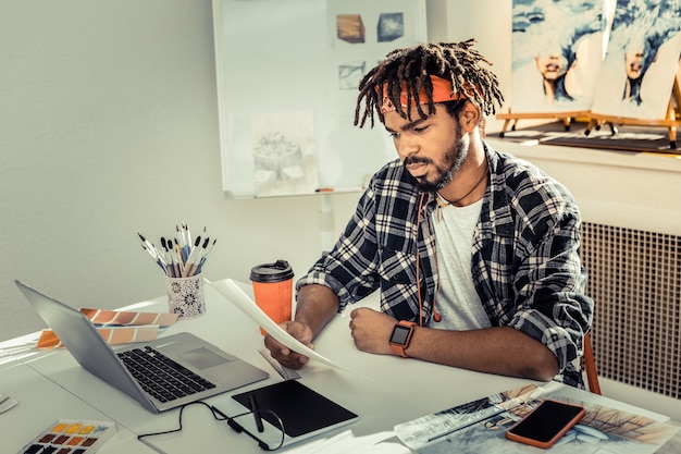 Nadenkende ontwerper. Jonge veelbelovende getalenteerde interieurontwerper die zich attent voelt tijdens het werken