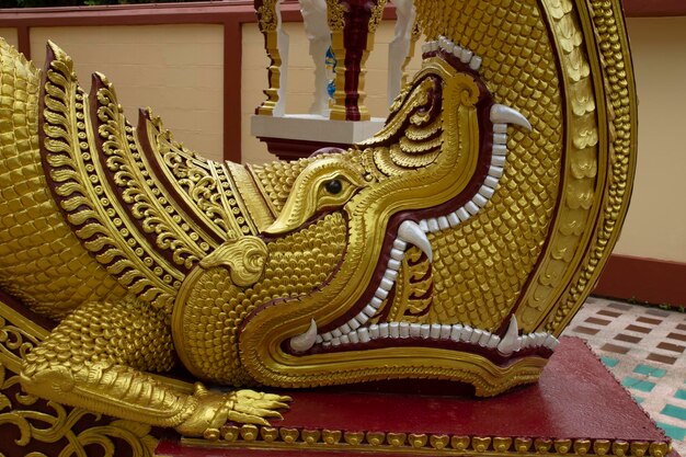 Naga sculpture painted in gold in a thai temple