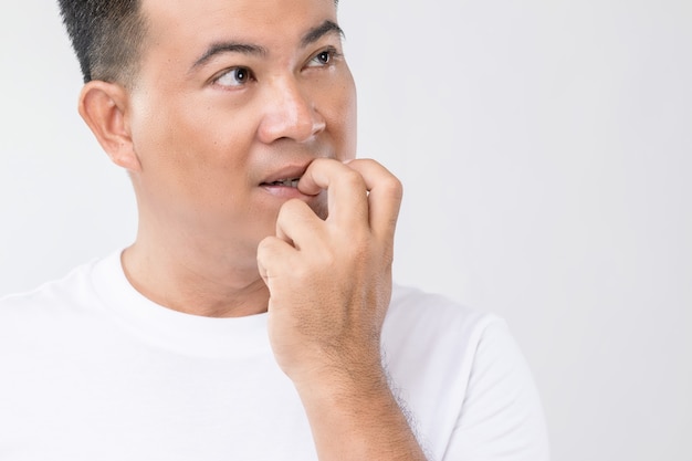 Nail Biting (Onychophagia) concept : Portrait people biting his nail. 