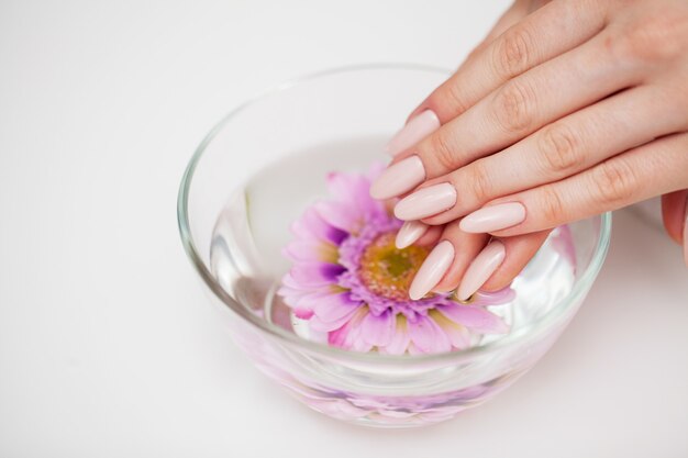 Nail care, woman demonstrates a fresh manicure done in a beauty studio