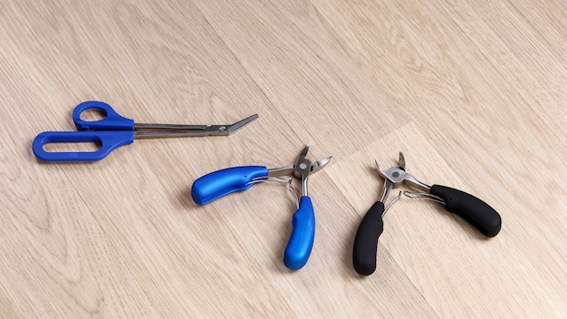 Nail cutting tool located on wooden floor