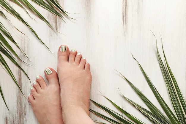 Nail design with green lines on the legs