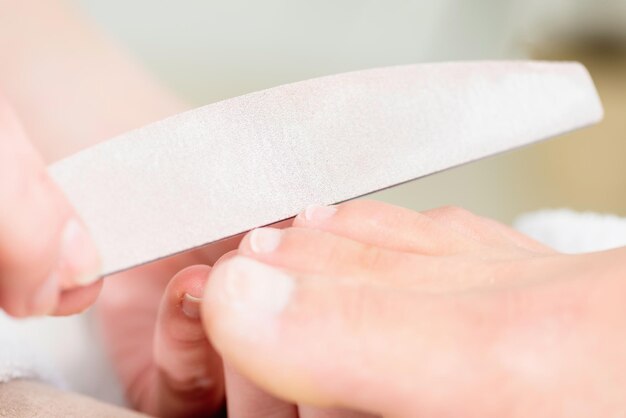 Photo nail filing in pedicure salon