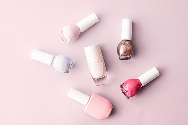 Nail polish bottles on blush pink background beauty brand