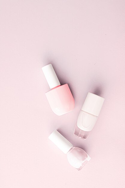 Nail polish bottles on blush pink background beauty brand