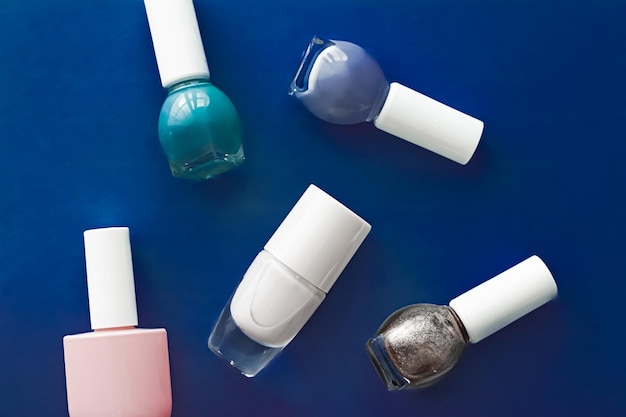 Photo nail polish bottles on dark blue background beauty brand