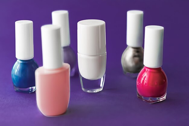 Nail polish bottles on dark purple background beauty brand