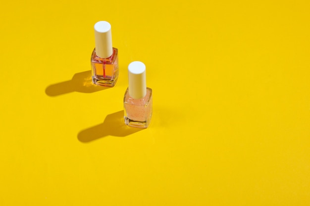 Nail polish bottles on a yellow