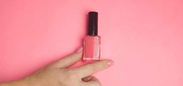 Nail polish in a woman's hand copy space Article about manicure Gel polish Hand care