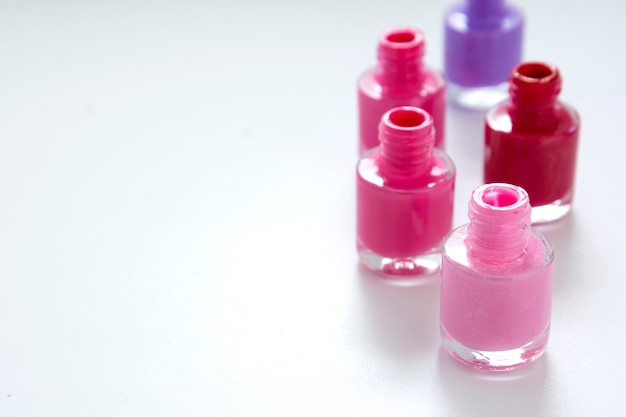 Nail polishbottles on white with copy space for text