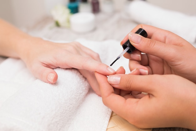 Nail technician giving customer a manicure