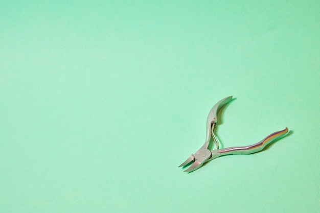 Nail tongs on a green background