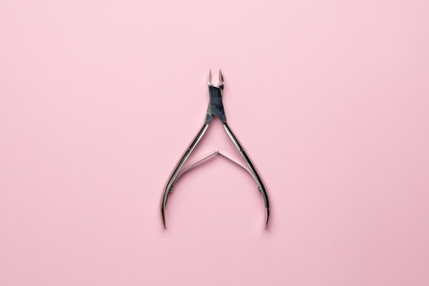 Nail tweezers on pink