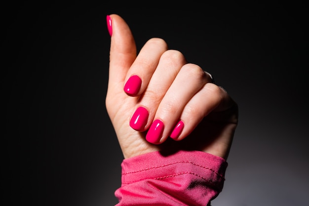 Nails Design. Hands With Pink Summer Manicure On Grey