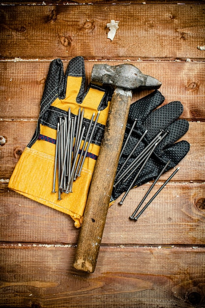 Nails with hammer and gloves