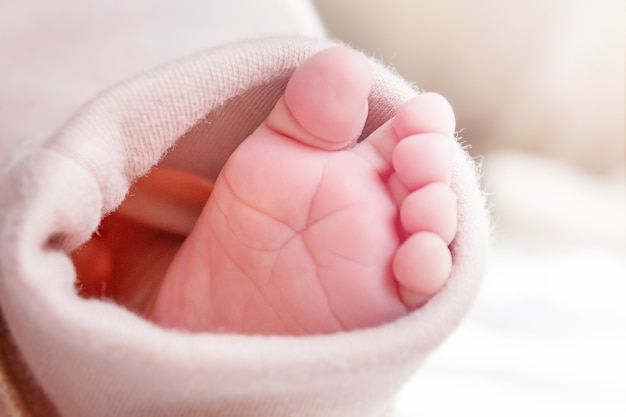 Naked caucasian newborn baby foot closeup