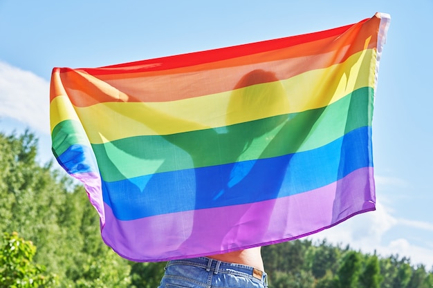 Naked woman wearing lgbt flag. High quality photo