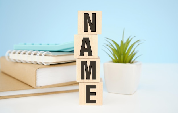 NAME word written on wood block. NAME text on wooden table for your desing, concept.