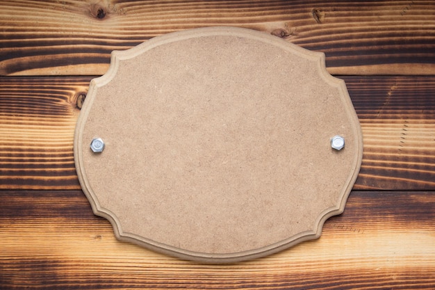 nameplate or wall sign at wooden background
