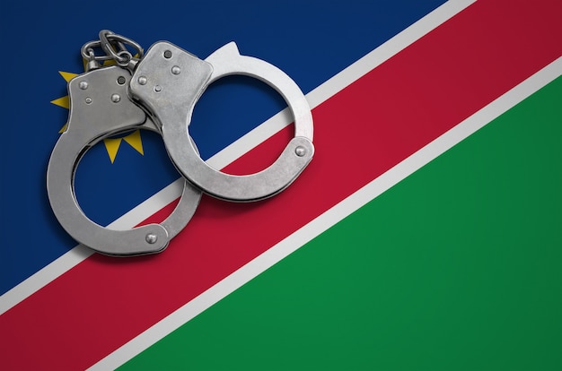 Namibia flag  and police handcuffs. The concept of crime and offenses in the country