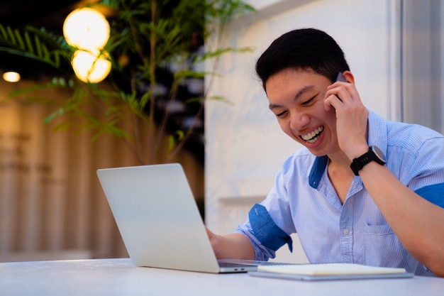 Nan smiling on call,using laptop. 